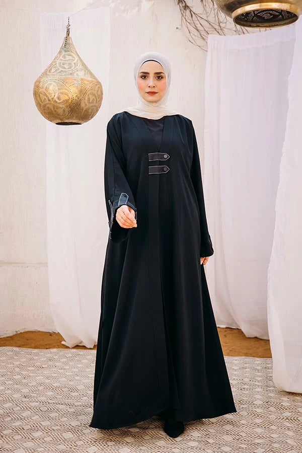 Cloche silk abaya with satin belts on sleeves and chest.