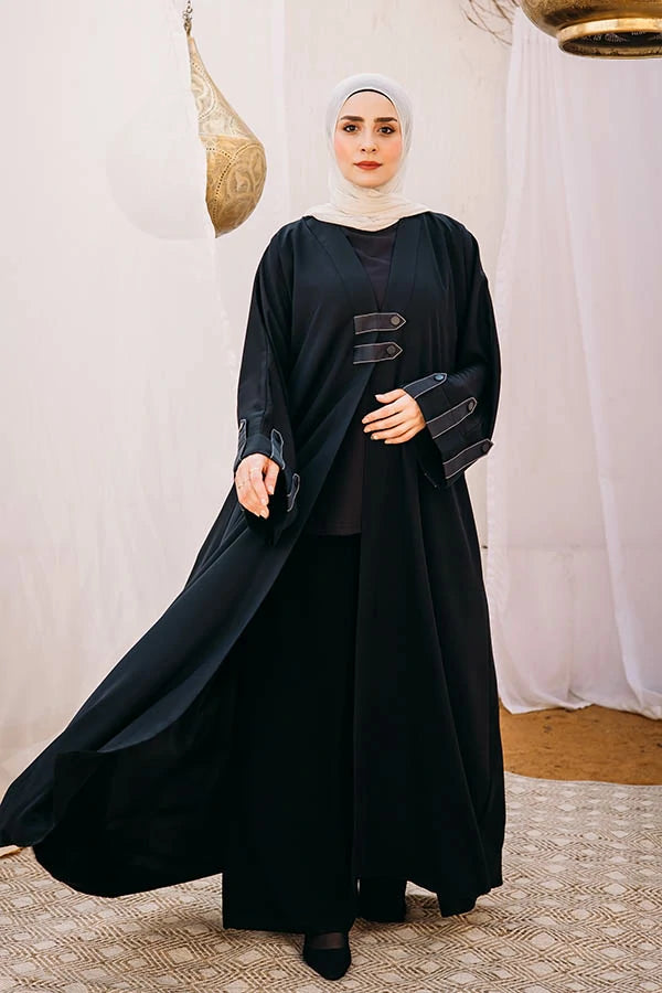 Cloche silk abaya with satin belts on sleeves and chest.