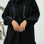 Black poplin shirt with light grey piping on pockets.